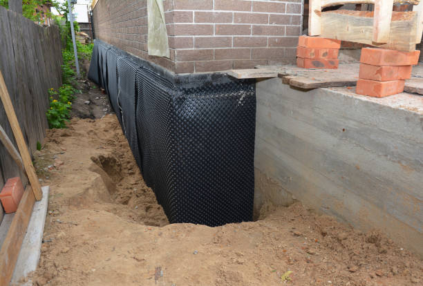 SJ Waterproofing Pros technician performing targeted Waterproofing assessment in Elwood, NY